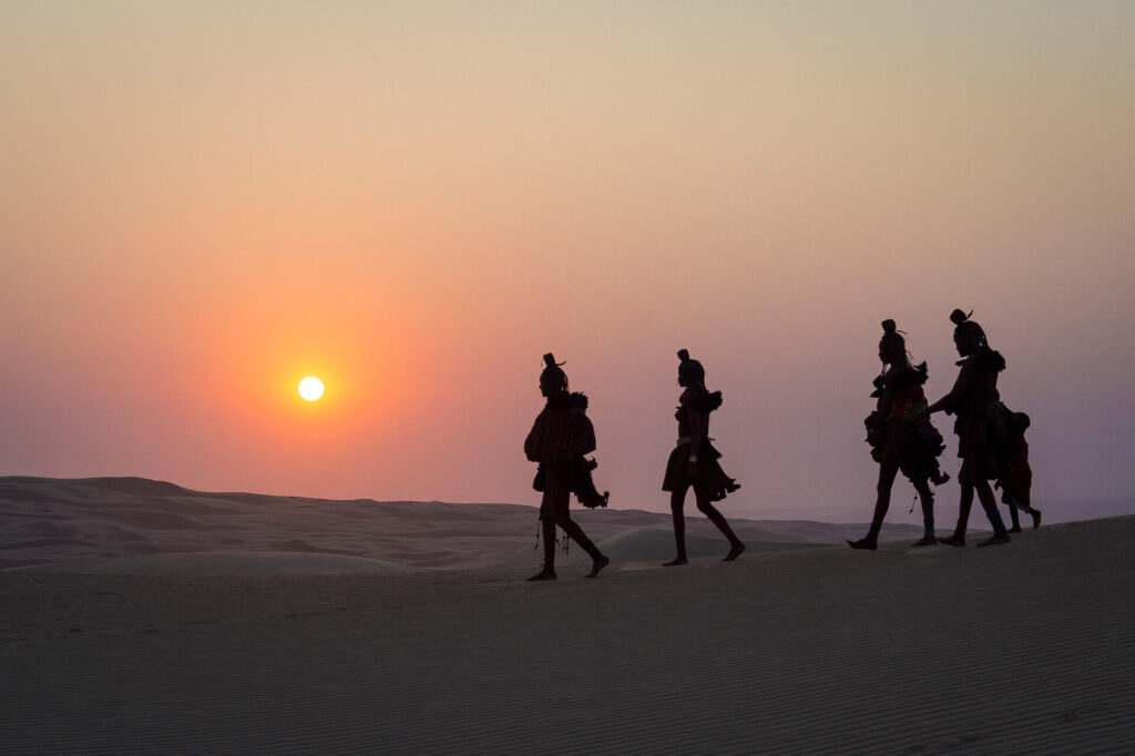 Himba women walking int he Namib Desert.