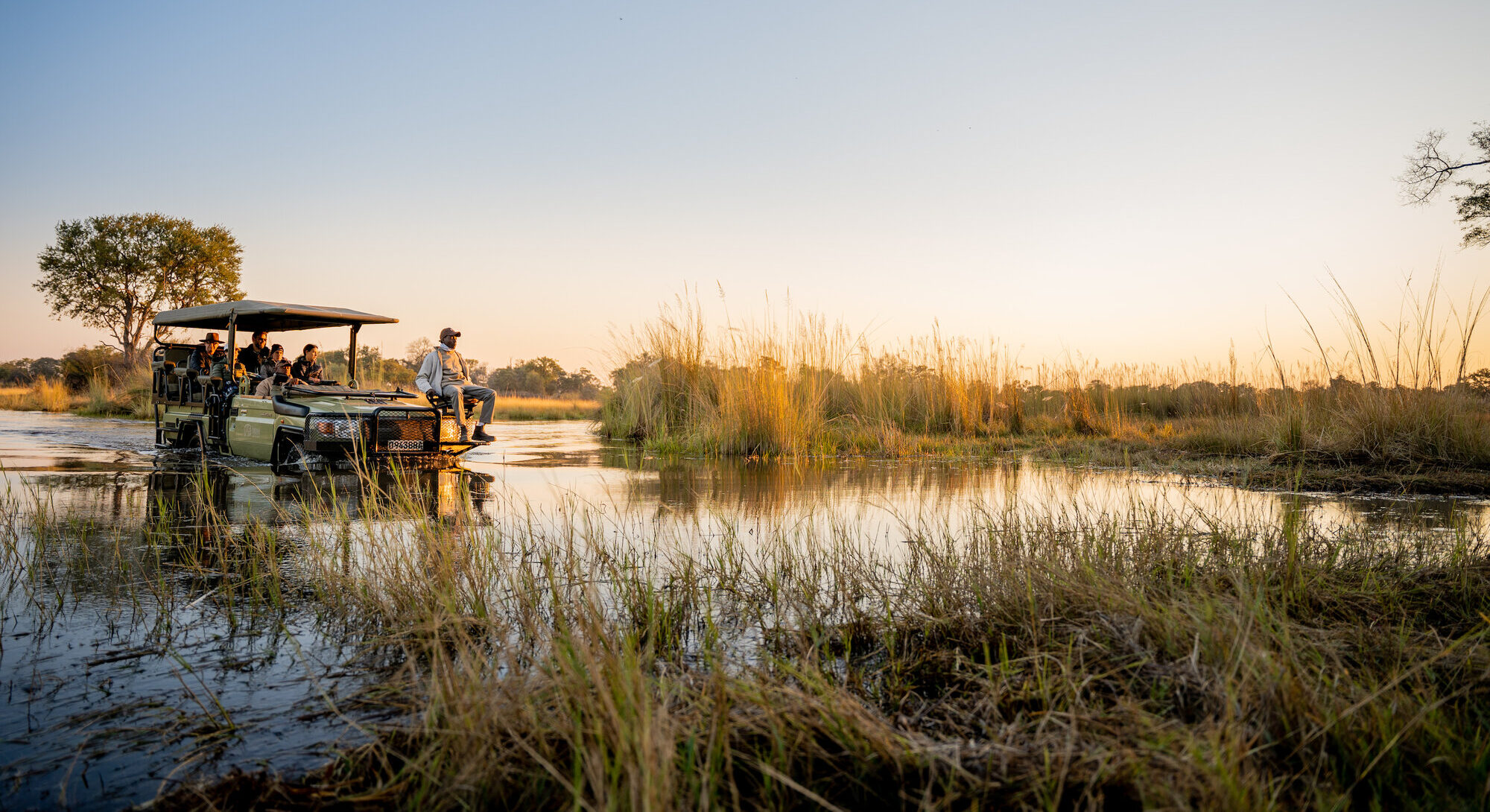 Safari group on an excursion into the flooded landscape of the Okavango Delta